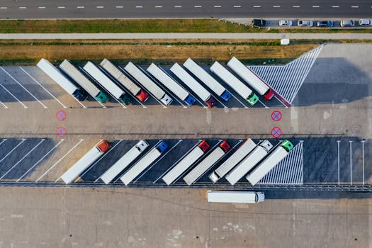 pexels-photo-2800121-2800121 Overhead shot of semi-trucks parked in Poznań, Poland, demonstrating transportation logistics.